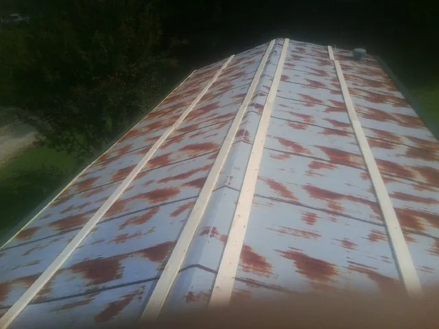 Rusted metal roof panels with new wood purlins before replacement — Storm Damage Roof Repair in Hollister by Roofing Brothers