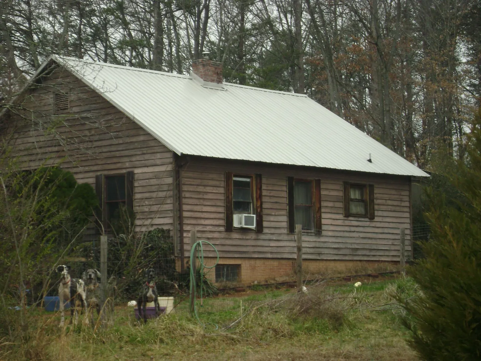 White metal roof on an old wood sided farmhouse, from a Asphalt Shingle Roof Repair job in Hollister